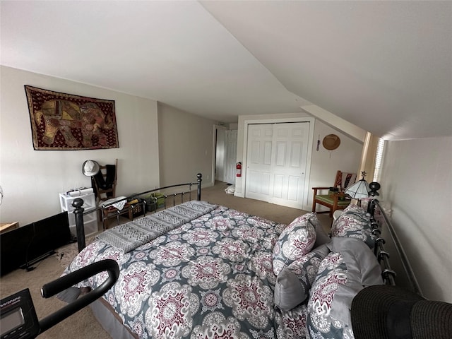 bedroom with a closet, carpet, and vaulted ceiling