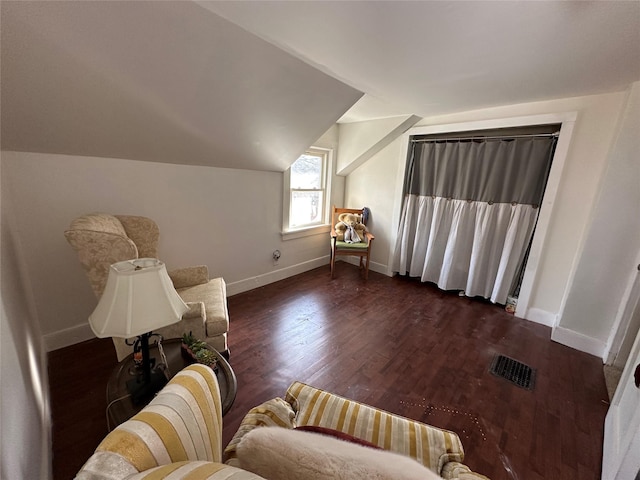 sitting room with dark hardwood / wood-style floors and lofted ceiling