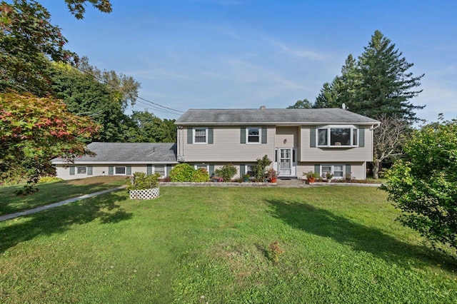 raised ranch with a front yard