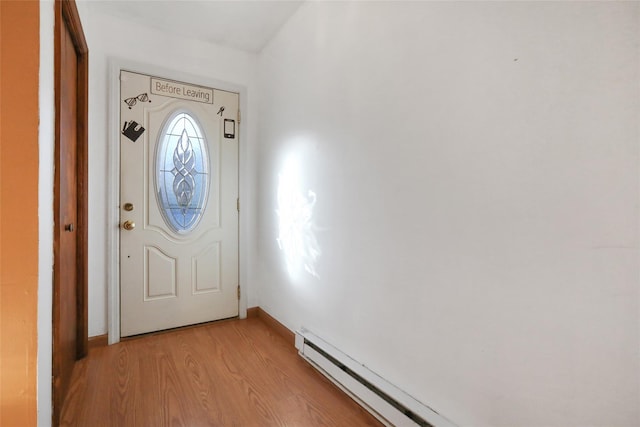 doorway with baseboard heating and light wood-type flooring