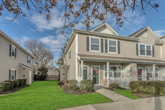 multi unit property with covered porch and a front yard