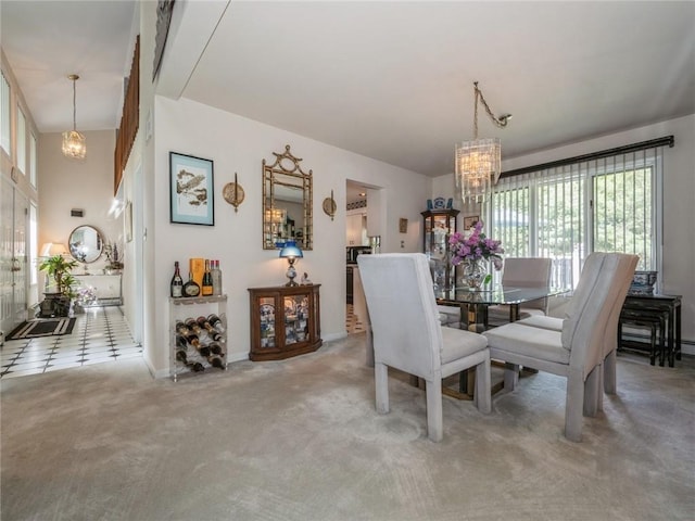 carpeted dining room with an inviting chandelier