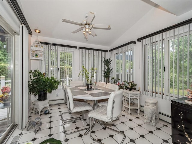 sunroom / solarium featuring a baseboard radiator, vaulted ceiling, plenty of natural light, and ceiling fan