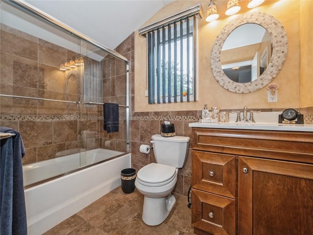 full bathroom featuring enclosed tub / shower combo, lofted ceiling, toilet, vanity, and tile walls