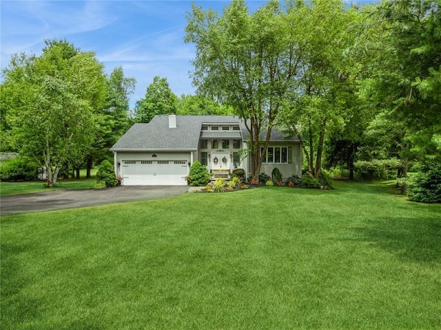 view of front of property with a garage and a front yard