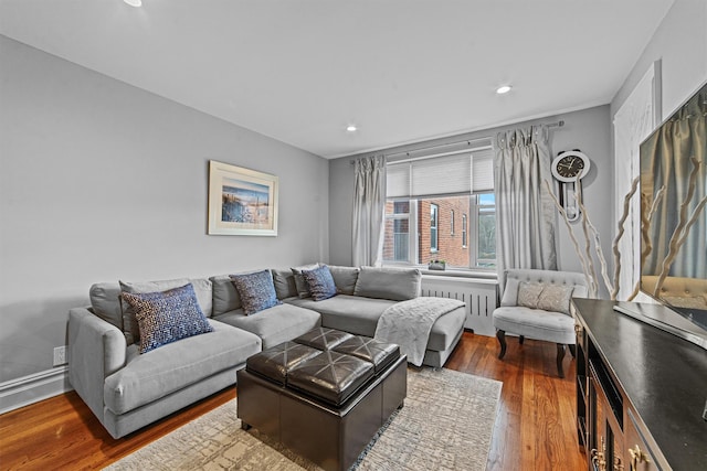 living room with radiator and dark hardwood / wood-style flooring