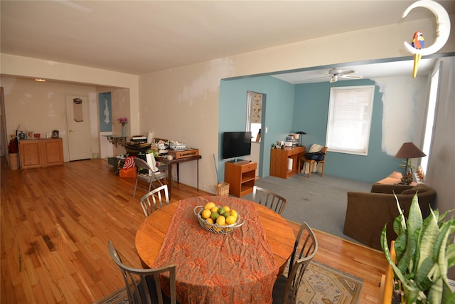 dining space featuring wood-type flooring and ceiling fan