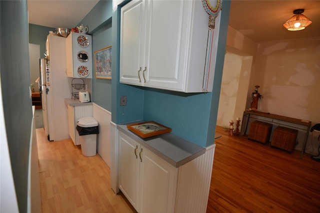 kitchen featuring white cabinetry and light wood-type flooring