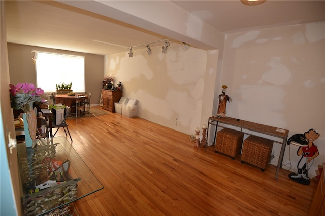 miscellaneous room featuring wood-type flooring and track lighting