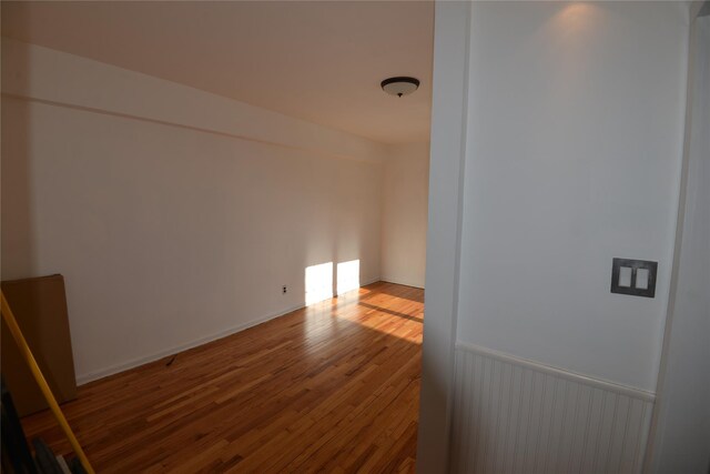 spare room featuring wood-type flooring