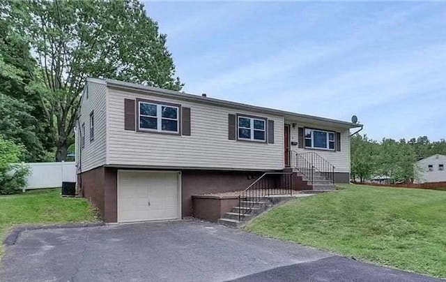 view of front of home featuring a garage and a front yard