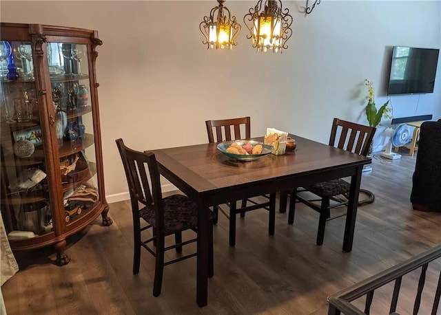 dining room featuring dark wood-type flooring and a chandelier