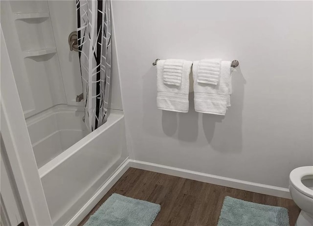 bathroom with shower / bath combination with curtain, toilet, and wood-type flooring