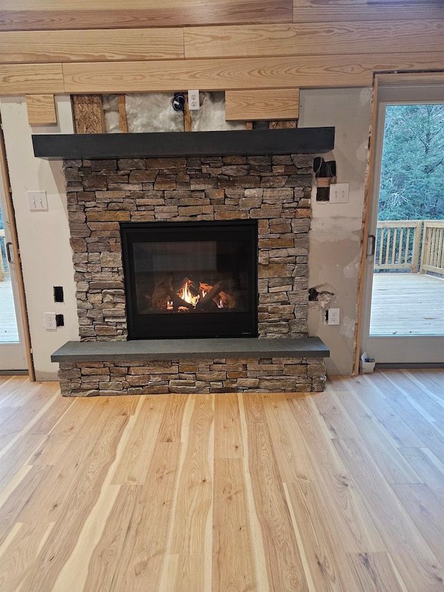 room details featuring hardwood / wood-style floors and a stone fireplace