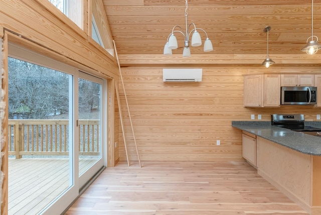 kitchen with light brown cabinetry, appliances with stainless steel finishes, decorative light fixtures, light hardwood / wood-style floors, and a chandelier