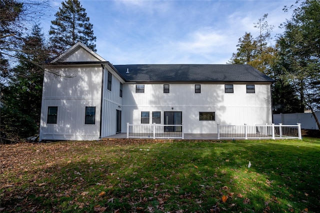 rear view of property with a lawn