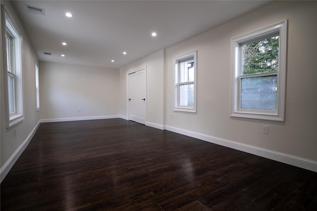 spare room featuring dark wood-type flooring