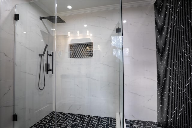 bathroom with a shower with shower door and crown molding