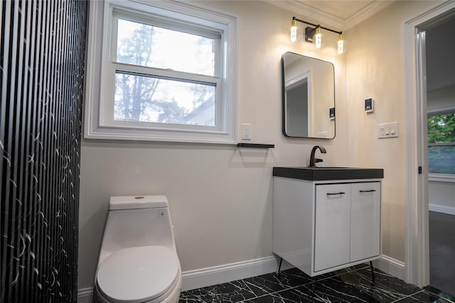 bathroom featuring crown molding, vanity, and toilet