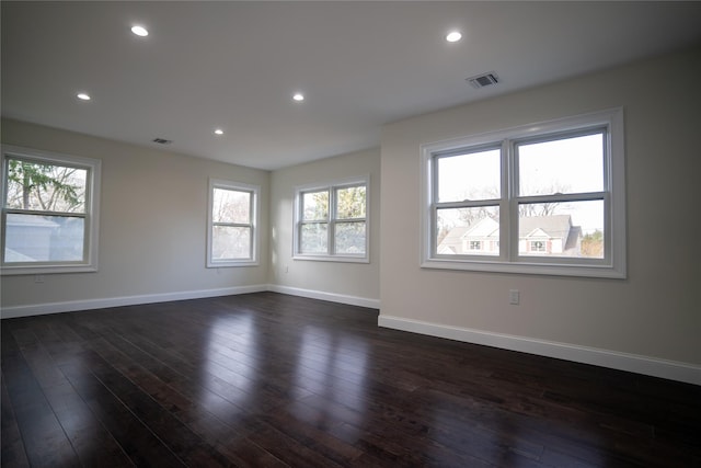 empty room featuring dark hardwood / wood-style floors and a healthy amount of sunlight