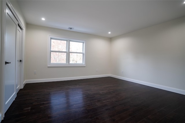 empty room with dark hardwood / wood-style floors