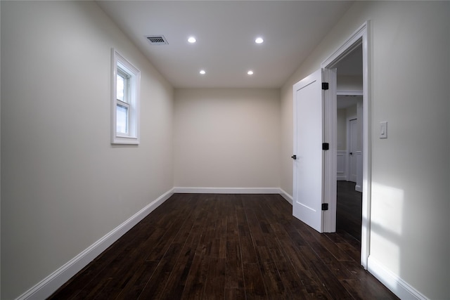 hallway with dark wood-type flooring