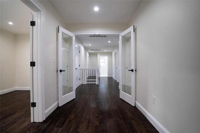 hall with french doors and dark hardwood / wood-style flooring