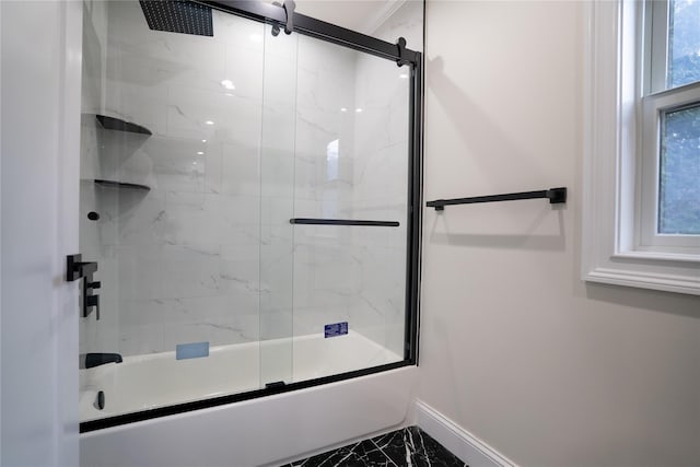 bathroom with combined bath / shower with glass door