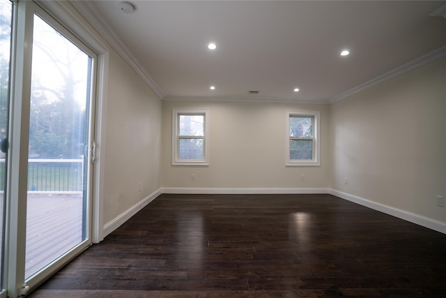 empty room with dark hardwood / wood-style floors and crown molding