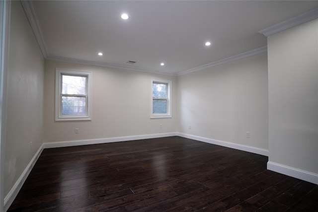 spare room featuring ornamental molding and dark wood-type flooring