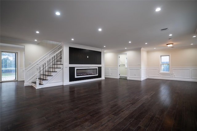 unfurnished living room featuring dark hardwood / wood-style flooring and ornamental molding