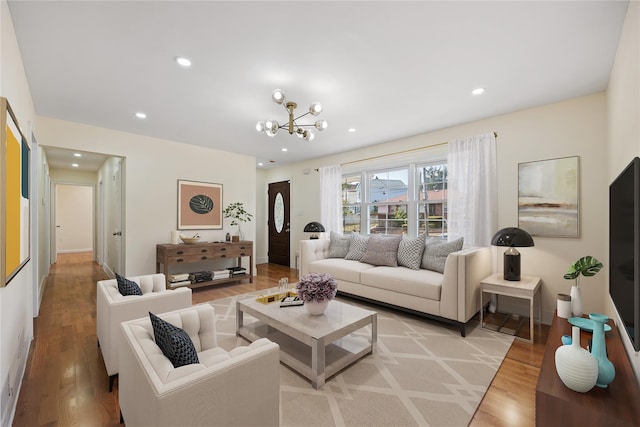 living room with light hardwood / wood-style flooring and a notable chandelier