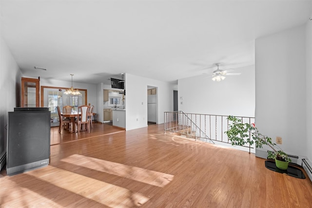 living room featuring ceiling fan and wood-type flooring