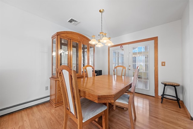 dining room featuring baseboard heating, french doors, light wood-type flooring, and a notable chandelier