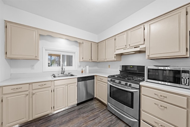 kitchen with dark wood-type flooring, sink, cream cabinetry, and appliances with stainless steel finishes