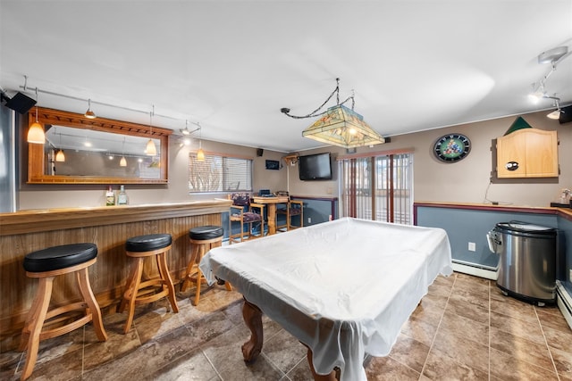 game room with bar area, pool table, and a baseboard radiator