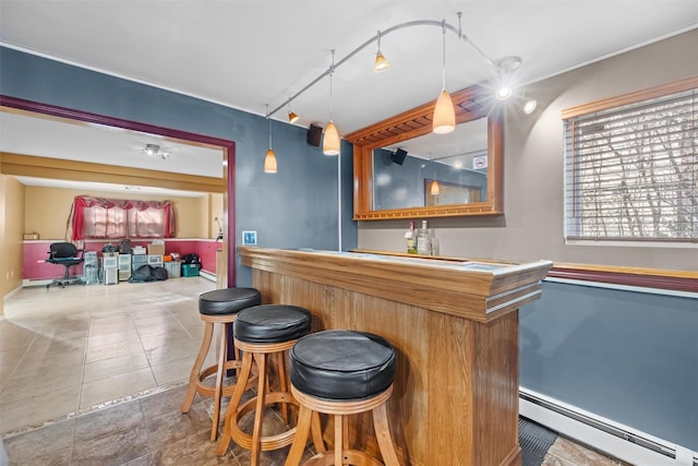 bar with baseboard heating, tile patterned flooring, rail lighting, and decorative light fixtures