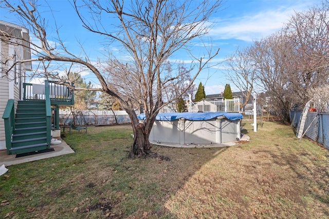 view of yard with a swimming pool side deck