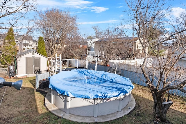 view of yard with a pool side deck and a storage shed