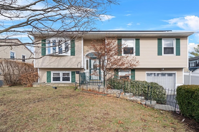 raised ranch with a front yard and a garage