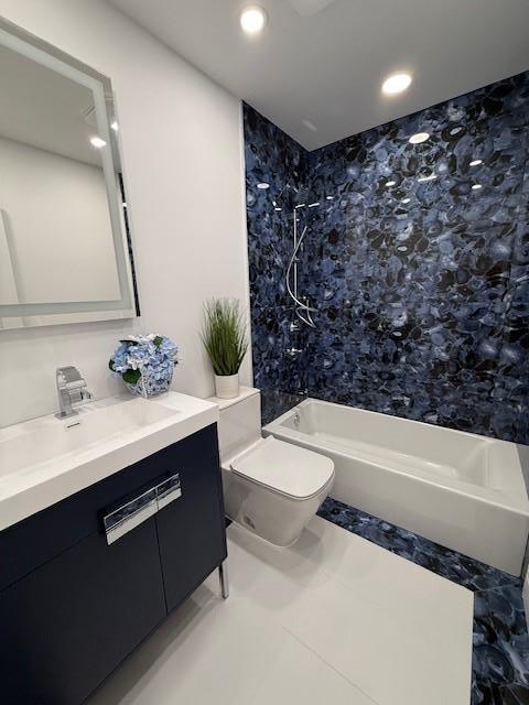 full bathroom with tile patterned floors, vanity, toilet, and tiled shower / bath