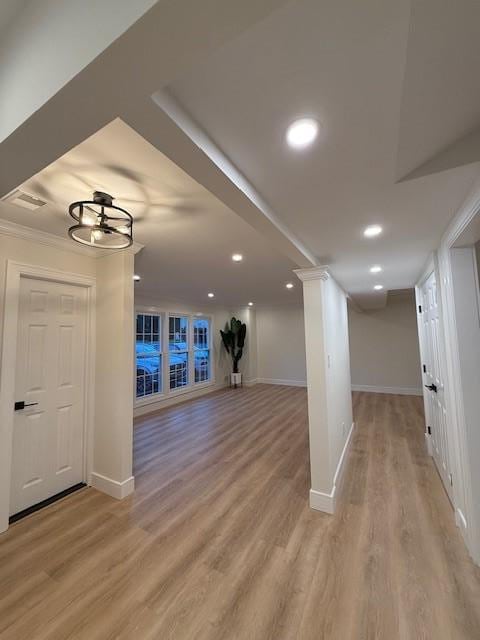 interior space featuring light hardwood / wood-style flooring and ornamental molding