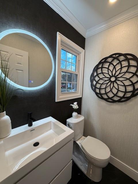 bathroom with vanity, toilet, and crown molding