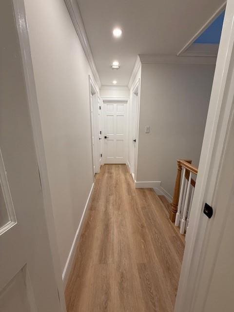 corridor featuring crown molding and light hardwood / wood-style floors