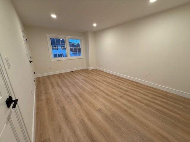 empty room with light hardwood / wood-style flooring