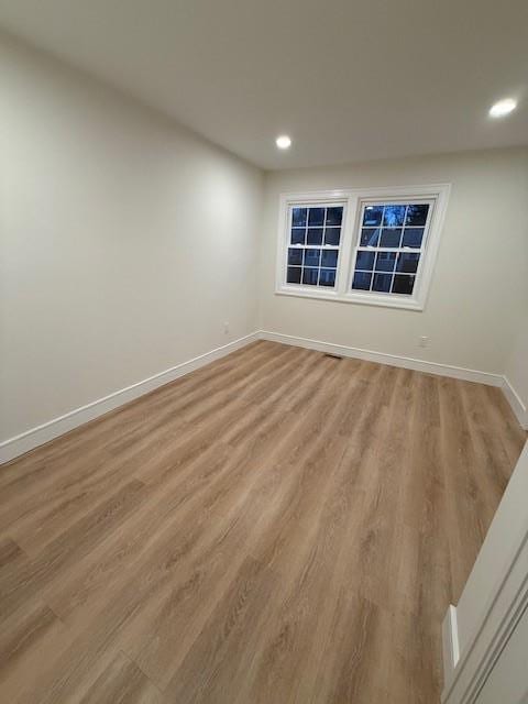 spare room featuring light hardwood / wood-style flooring