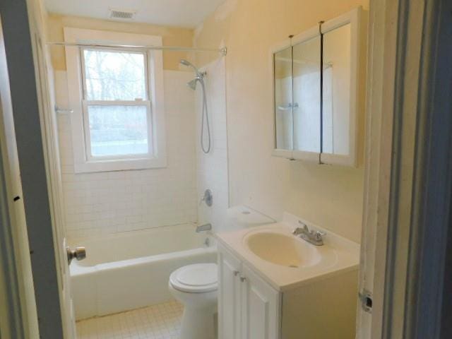 full bathroom with tile patterned flooring, vanity, toilet, and tiled shower / bath