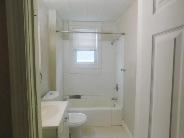 full bathroom with tile patterned flooring, vanity, tiled shower / bath combo, and toilet