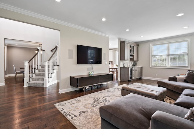 living room featuring wine cooler, sink, dark hardwood / wood-style flooring, and ornamental molding