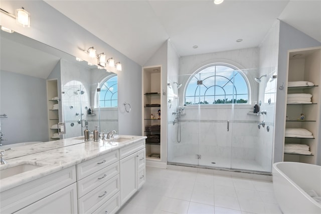 bathroom featuring independent shower and bath, vanity, a healthy amount of sunlight, and vaulted ceiling